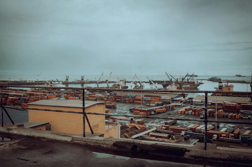Tema Port in Ghana with shipping containers and cranes, illustrating Africa freight forwarding trade lanes and partner coverage.