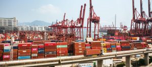 Cargo containers and cranes at a major Asian port, representing digital freight network membership across Asia trade lanes