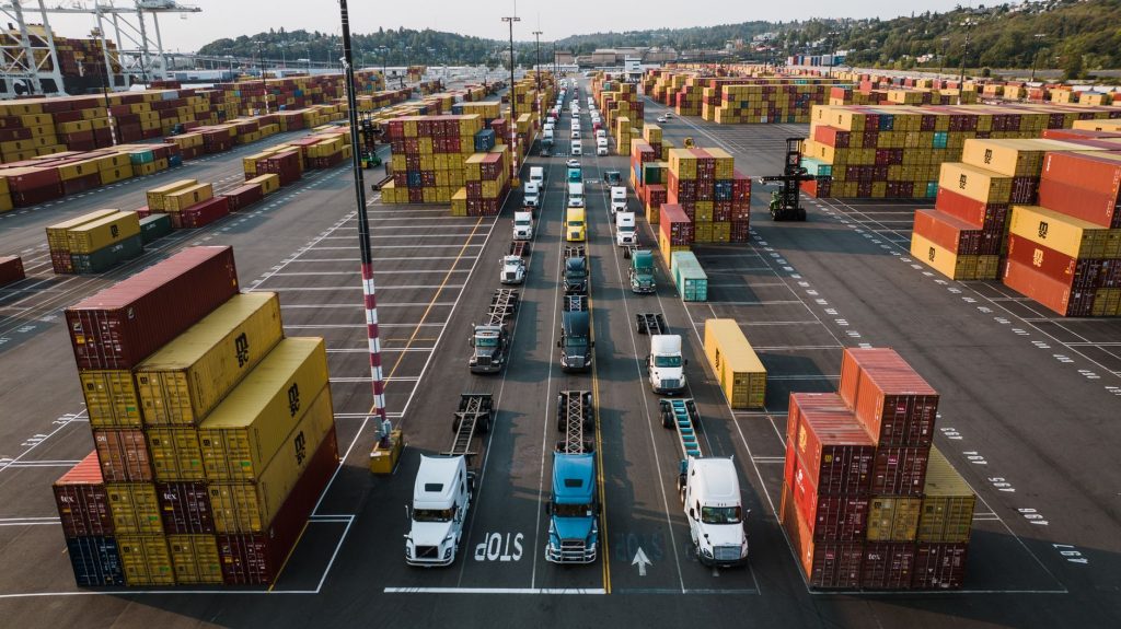 Freight containers and trucks representing North America trade lane expansion for freight forwarders across the U.S., Canada, and Mexico
