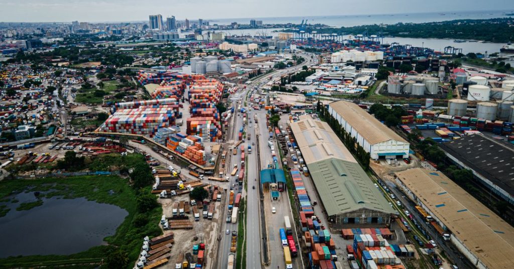 Aerial view of Dar es Salaam port with container yards, illustrating African freight corridor coordination.