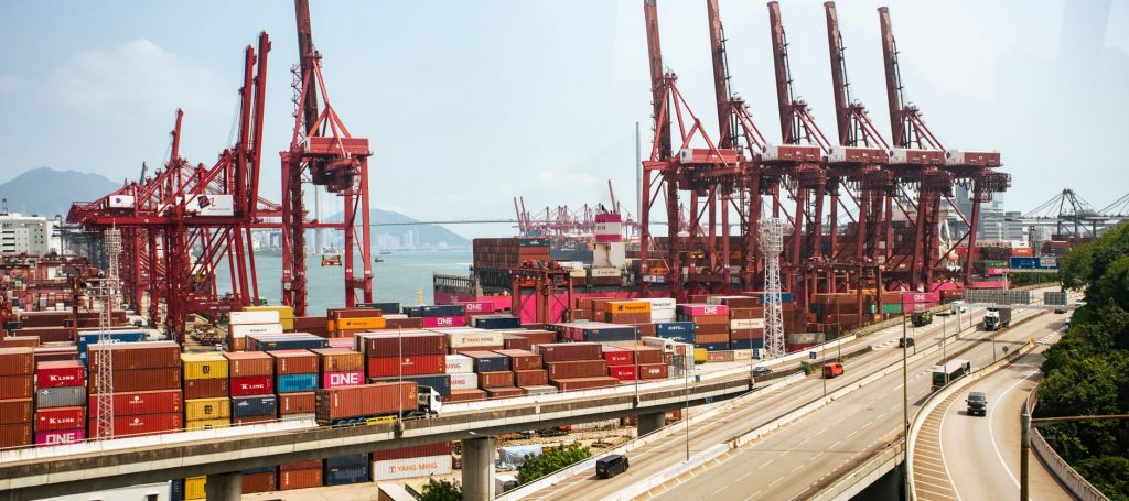 Hong Kong container port showing cranes and stacked containers for Asia freight network coverage
