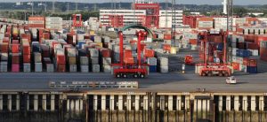 Cargo containers and cranes at a European seaport, representing freight network membership for EU and UK forwarders