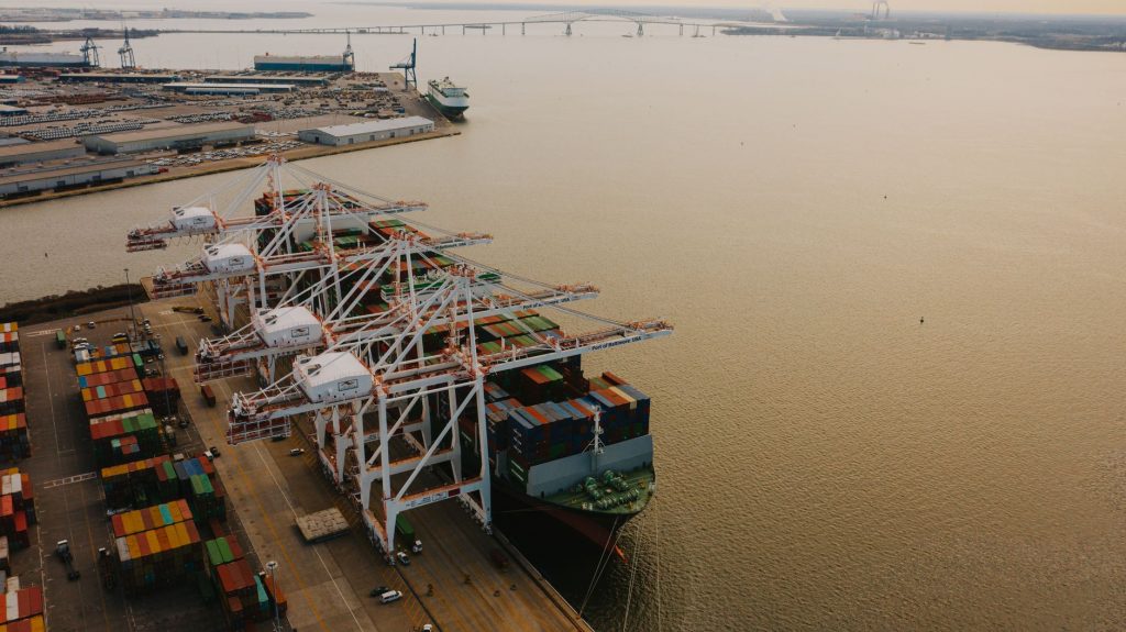 Container vessel loading at a North American port, representing cross-border freight network coverage across the U.S., Canada, and Mexico
